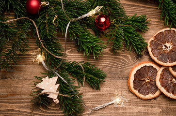 Christmas fir branch and orange slices on the table. View from above.