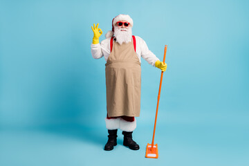 Full length body size view of nice cheerful Santa wiping cleansing floor doing domestic housework...