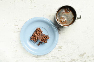 Chocolate bar on a plate with coffee