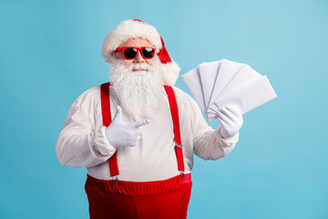 Fototapeta na wymiar Portrait of his he cheery confident thick white-haired Santa holding in hand demonstrating mail gifts wish list Eve Noel December tradition isolated bright vivid shine vibrant blue color background