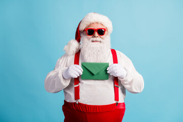 Fototapeta na wymiar Portrait of his he nice attractive cheery confident overweight white-haired Santa holding in hands letter wish list fairy tradition isolated bright vivid shine vibrant blue color background