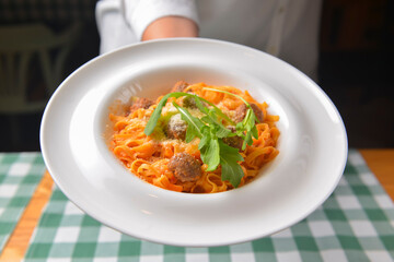 Healthy spaghetti dinner. Traditional Italian pasta with meatballs and cheese. Italian cuisine concept.