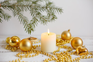 Christmas background, Golden Christmas toys , beads and a burning candle. Greeting card with Christmas