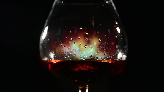 Close-up of brandy glasses on the background of the fireplace