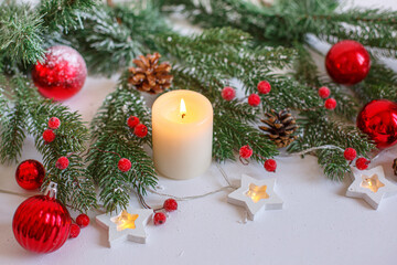 Christmas background, red Christmas toys , beads and a burning candle. Merry Christmas greeting card
