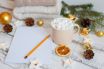 Christmas background with blank notebook, fir branches, decorations and gift box. Space for text. Top view. Christmas to-do list or wish list. Merry Christmas greeting card