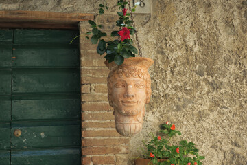 ceramic hanging flower pot with the image of a smile face