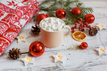 Christmas background,  coffee mug and marshmallows , red Christmas toys, glowing lights . Merry Christmas greeting card