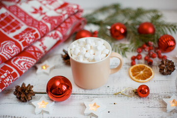 Christmas background,  coffee mug and marshmallows , red Christmas toys, glowing lights . Merry Christmas greeting card