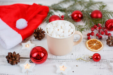 Christmas background,  coffee mug and marshmallows , red Christmas toys, glowing lights . Merry Christmas greeting card