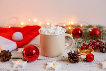 Christmas background,  coffee mug and marshmallows , red Christmas toys, glowing lights . Merry Christmas greeting card