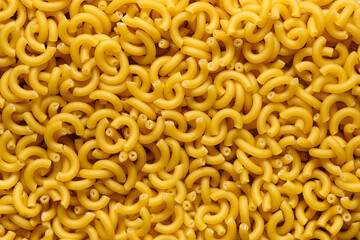 Background Italian pasta hard varieties, closeup. Culinary background, macro, horizontal frame. Raw food background or texture close up.