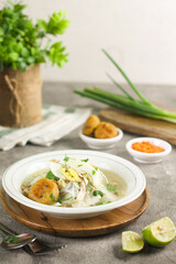 Soto Banjar, Indonesian traditional cuisine from South Kalimantan. The ingredients include ketupat, egg, chicken slices. Served with sambal anda lime. Served on Idul adha and Idul Fitri celebration.