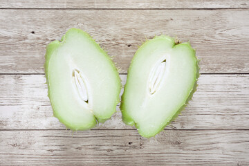 Top view of fresh ripe chayote fruits (Sechium edulis) on a wooden table