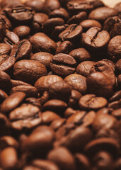 Closeup fresh roasted coffee beans background. Pile coffee texture beans. Selective focus