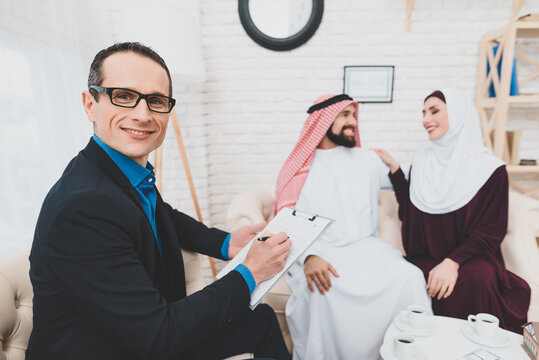 A male realtor is looking at the camera. 