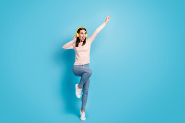 Fototapeta na wymiar Full length body size view of her she nice attractive pretty cheerful cheery girl fan jumping listening hit bass dancing isolated over bright vivid shine vibrant blue color background