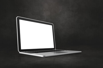 Laptop computer on dark concrete office scene background