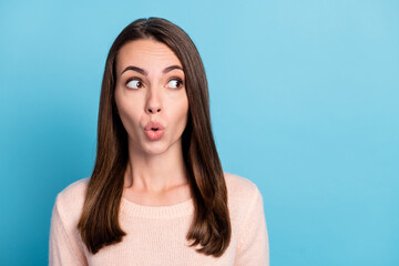 Photo of astonished girl look on empty space with open mouth wear beige clothes isolated over blue...