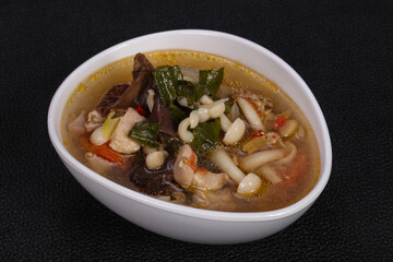 Thai style soup with meat and mushrooms