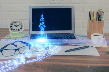 Desktop computer background in office and start up theme hologram drawing. Double exposure. Startup...