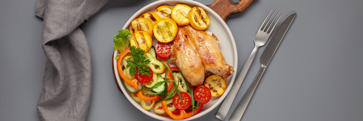 Diet lunch - chicken breast with zucchini grill and fresh vegetables. Top view