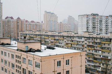 Rooftops and high residential buildings covered by snow in winter in the Obolon district of Kiev, Ukraine