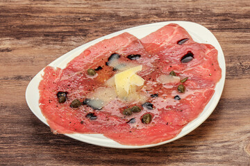 Carpaccio with capers, oil and parmesan