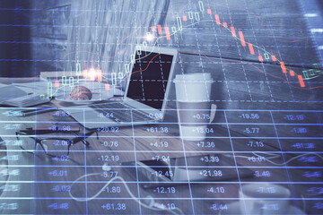 Forex market graph hologram and personal computer on background. Multi exposure. Concept of...