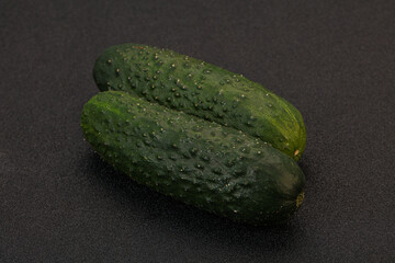 Green fresh cucumbers over background