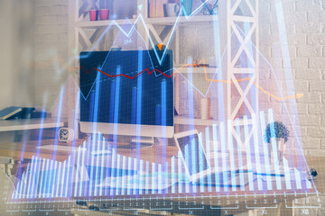 Double exposure of chart and financial info and work space with computer background. Concept of international online trading.