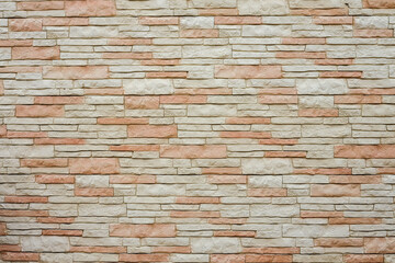 Cream and red brick wall texture background. Tiled.
