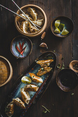 Assortment of asian japanese gyoza dumplings on a wooden background top view