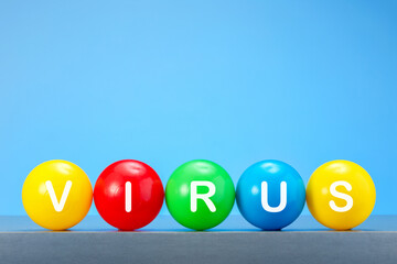 Virus, flu concept. Colorful balloons with word VIRUS against blue background with copy space.