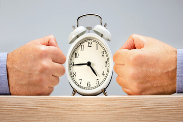 Hands of man pressure on a time. Concept of time management.