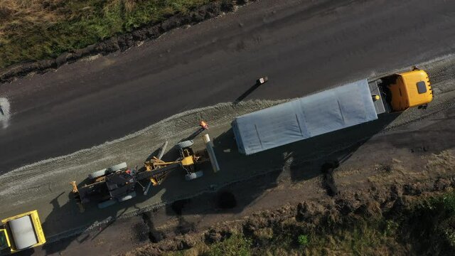 Road repair. Road repair equipment. Roller, dump truck. Next to the equipment is a worker. Shooting with a compter
