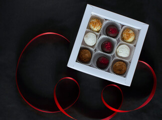 Homemade chocolate truffle candies on a dark background. in a gift box. Chocolate round candies for the holiday.