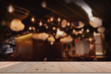 Wooden board empty table in front of blurred background. Perspective brown wood over blur in coffee shop.