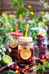 Healthy homemade cold lemonade with fresh berries and fruits in mason jar