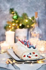 Meringue roll cake with cream and fresh berries