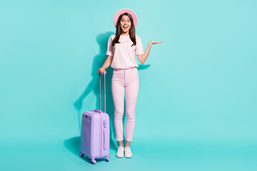 Full length body size view of her she nice attractive pretty slim cheerful amazed girl holding bag copy space on palm isolated bright vivid shine vibrant green turquoise color background
