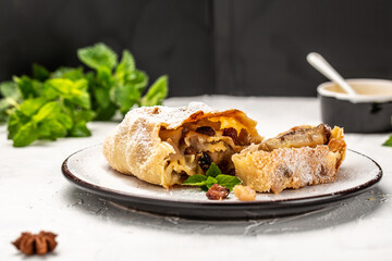 Pear spicy strudel, Sweet strudel with pear with cinnamon, raisin, powdered sugar and mint. austrian germany food