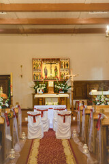 Church sanctuary before a wedding ceremony. Empty chairs for bride and groom.