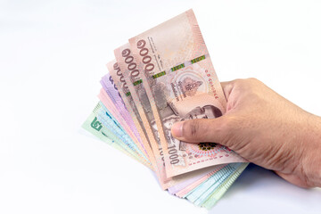 money banknote thai baht in hand close-up, (savings, shopping, pay, borrow concept), hand holding paper money