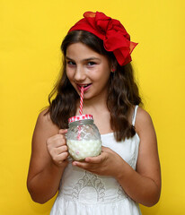 Cheerful young  girl posing with milk. Christmas cookies. Holiday  baking concept.