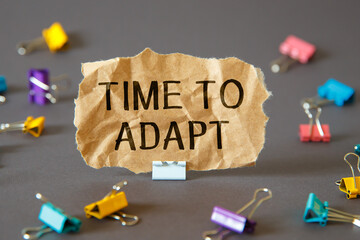 TIME TO ADAPT - inscription on paper.