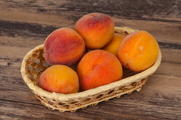 Peach heap in the wooden basket