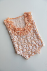 Various colors and types of cotton clothing, knitted newborn clothes and newborn hats on a white background.