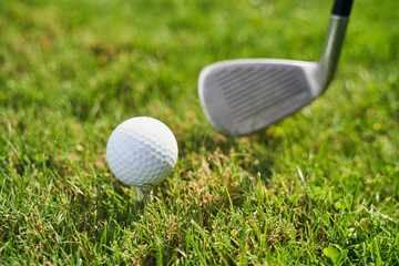 Golfing kit on the sunlit green grass