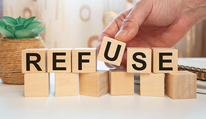 REFUSE - word wooden cubes on white background